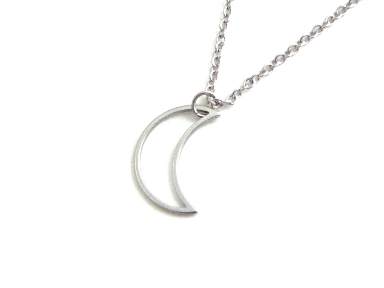 hollow crescent moon charm on a stainless steel chain
