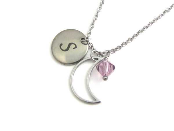 laser engraved capital initial letter disc charm, a hollow crescent moon charm and a light purple crystal charm on a stainless steel chain