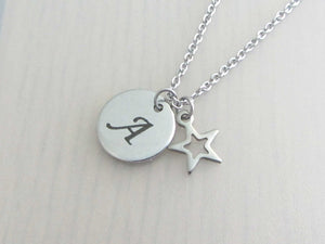 laser engraved capital initial letter disc charm and hollow star charm on a stainless steel chain