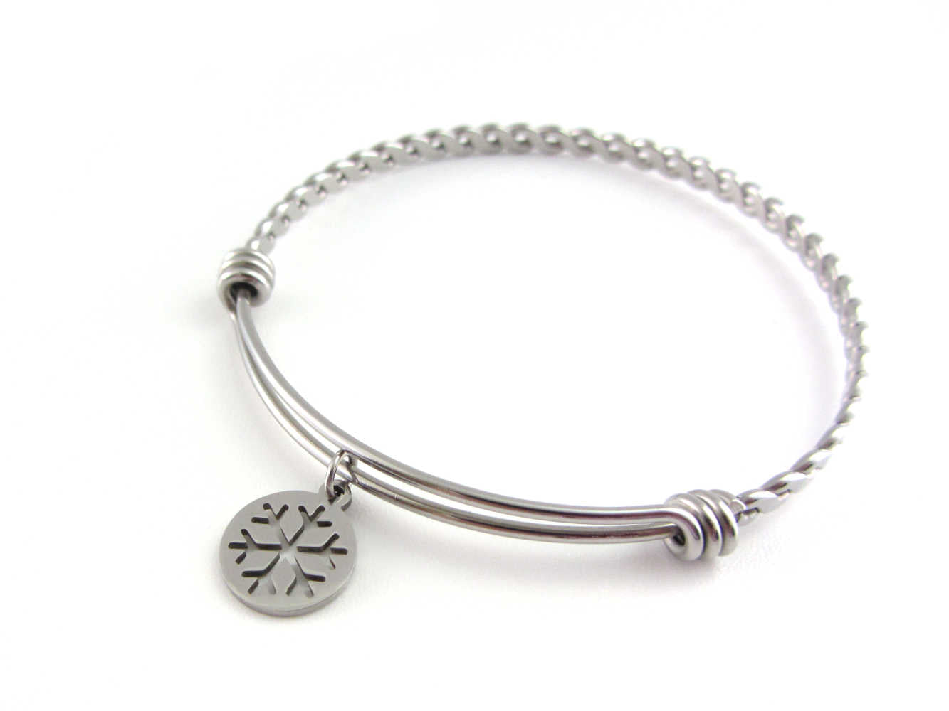stainless steel snowflake charm on a bangle with braided twist pattern