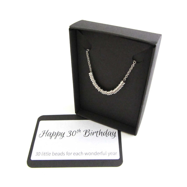 30 stainless steel beads one for each year necklace on a stainless steel chain shown in black gift box with happy 30th birthday message card