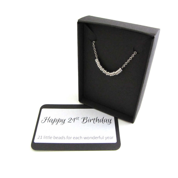 21 stainless steel beads one for each year necklace on a stainless steel chain shown in black gift box with happy 21st birthday message card