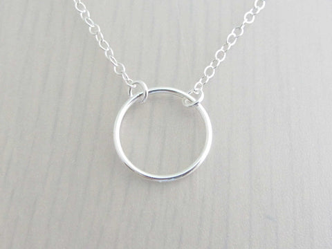 silver circle ring on a silver chain