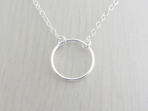 silver circle ring on a silver chain