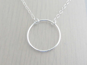 silver circle ring on a silver chain