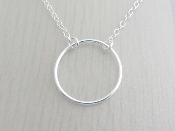 silver circle ring on a silver chain