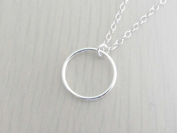 silver circle ring on a silver chain