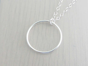 silver circle ring on a silver chain