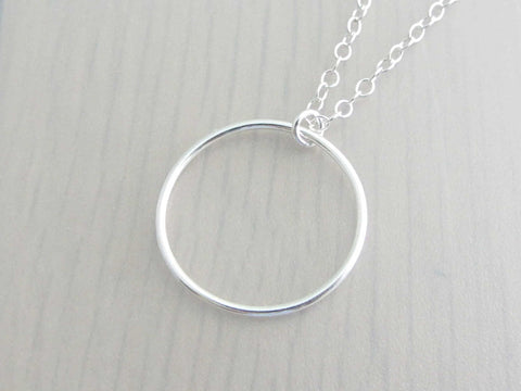 silver circle ring on a silver chain