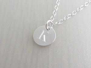 silver engraved capital initial letter disc charm on a silver chain