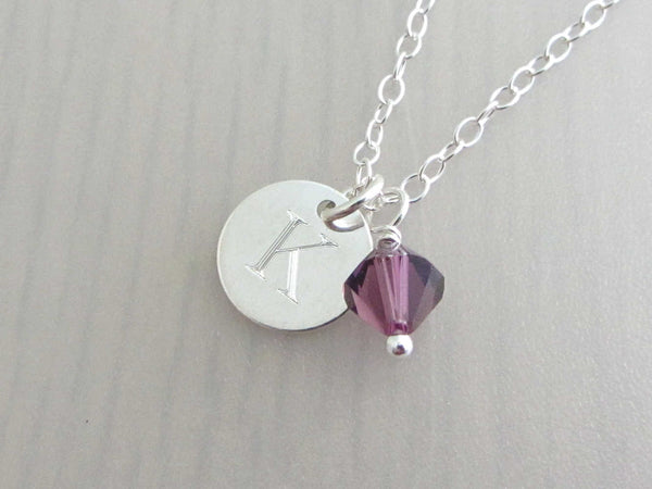 silver engraved capital initial letter disc charm and purple coloured crystal charm on a silver chain