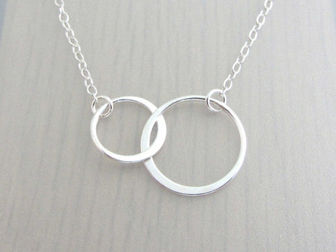 two linked silver circle rings on a silver chain