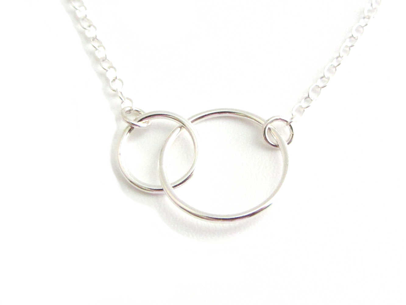 two linked silver circle rings on a silver chain