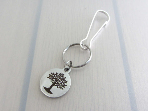 laser engraved tree charm on a bag charm