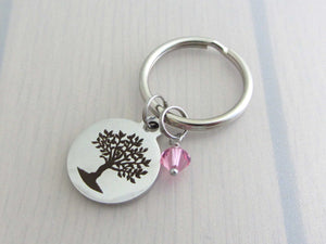 laser engraved tree charm and a pink crystal charm on a keyring
