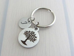 laser engraved capital initial letter disc charm and a laser engraved tree charm on a keyring
