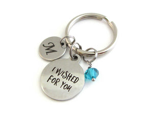 laser engraved capital initial letter disc charm, a laser engraved "I wished for you" charm and a blue/green crystal charm on a keyring