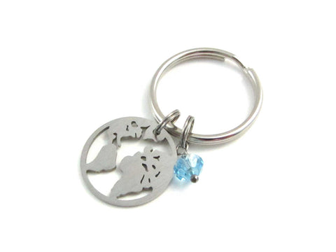 stainless steel world earth map charm and a light blue crystal charm on a keyring