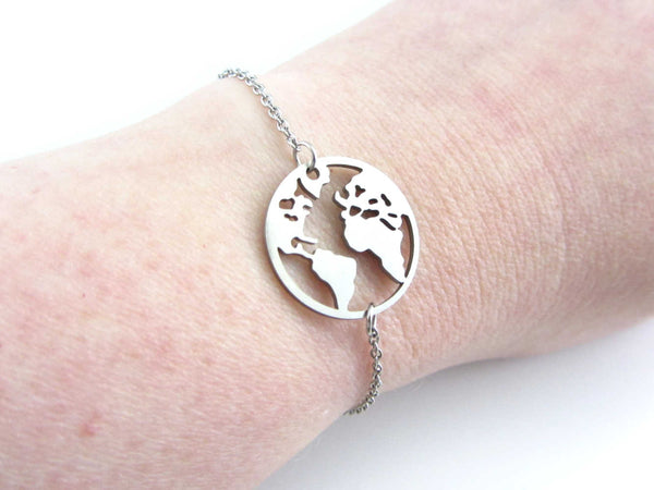 world globe earth map charm on a stainless steel chain on wrist