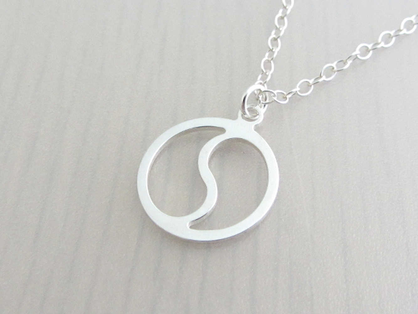 silver yin yang charm on a silver chain